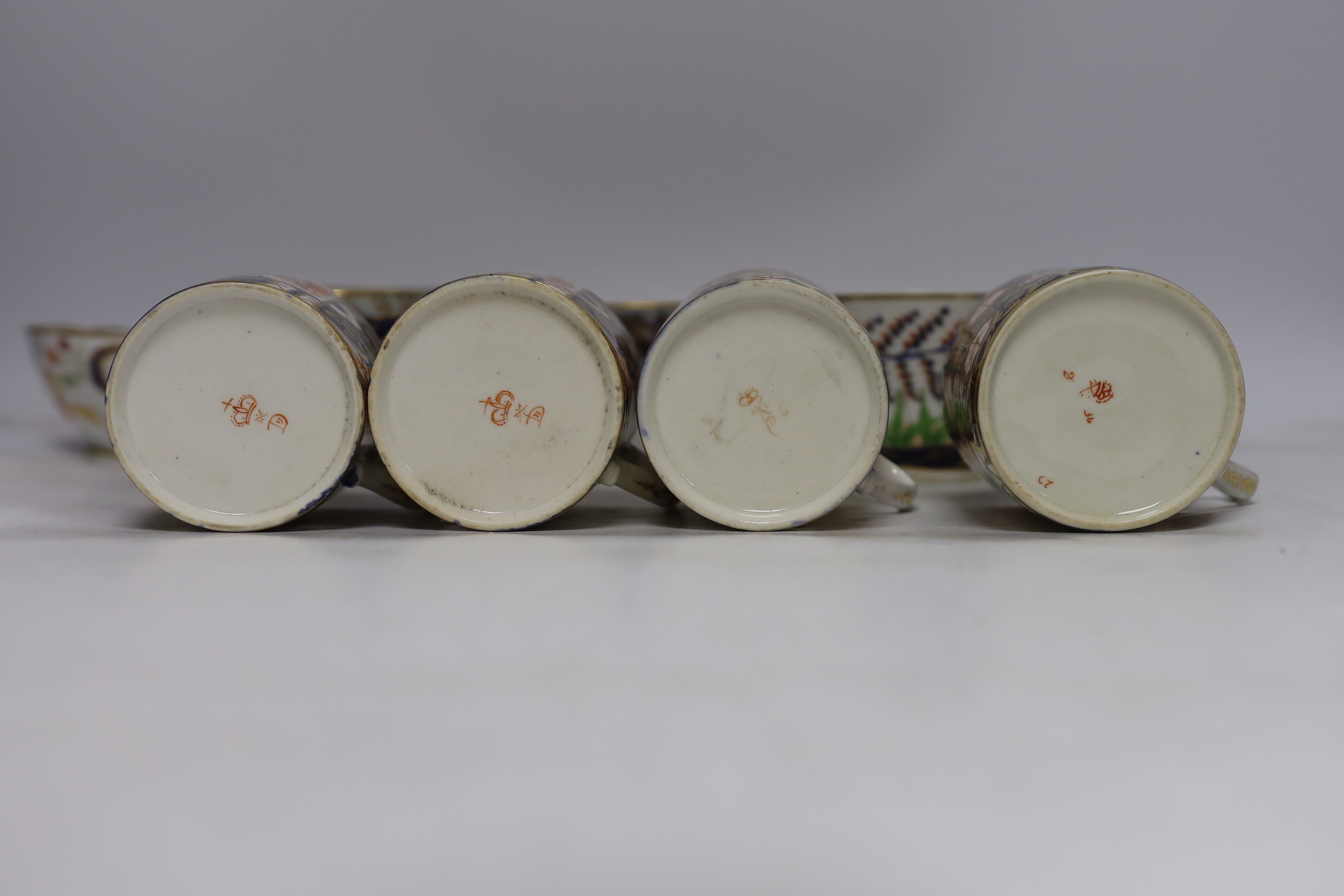 Eleven 1800-1820 English porcelain coffee cans and tea cups, including Imari pattern examples, one with matching saucer